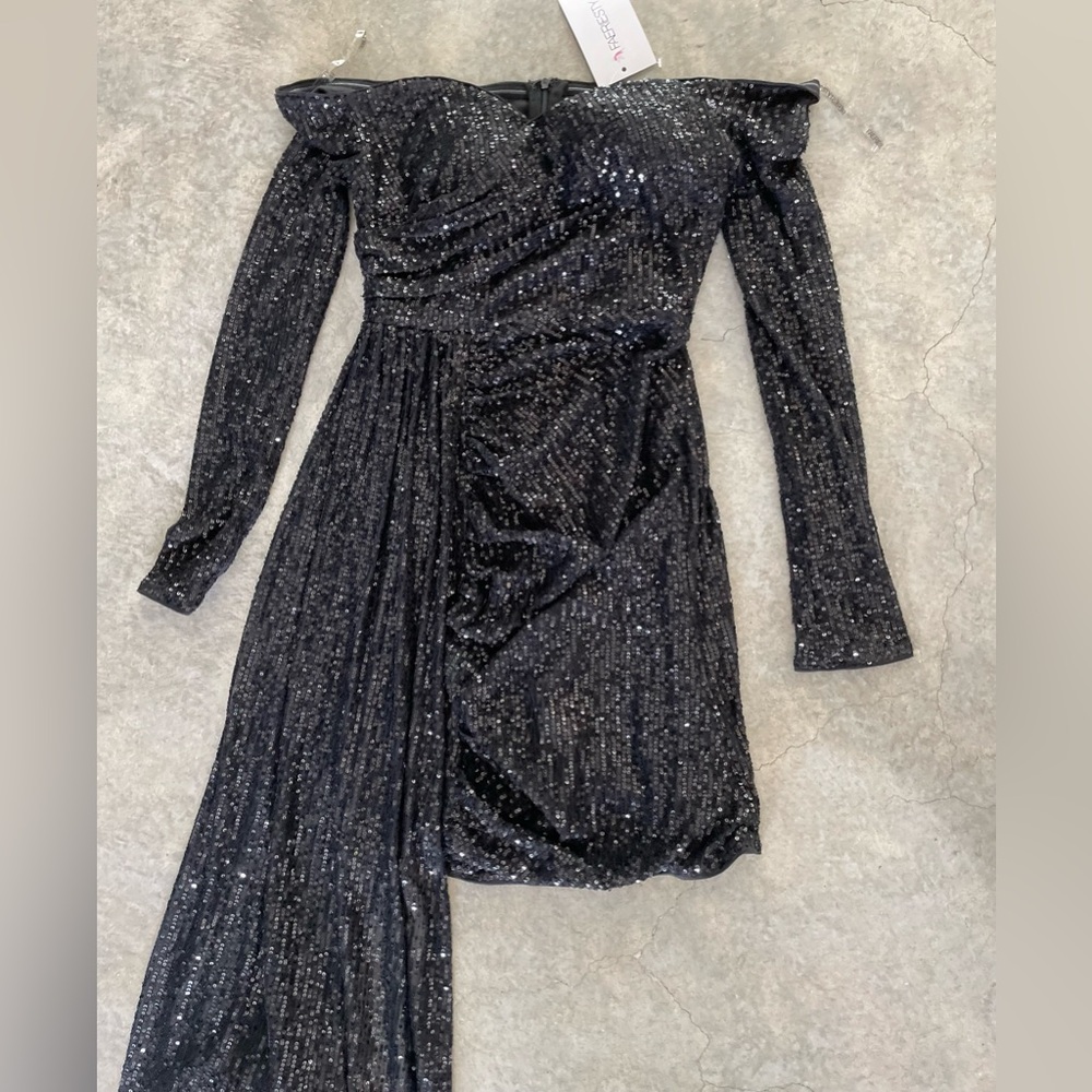 A black mini dress embellished with sequins.